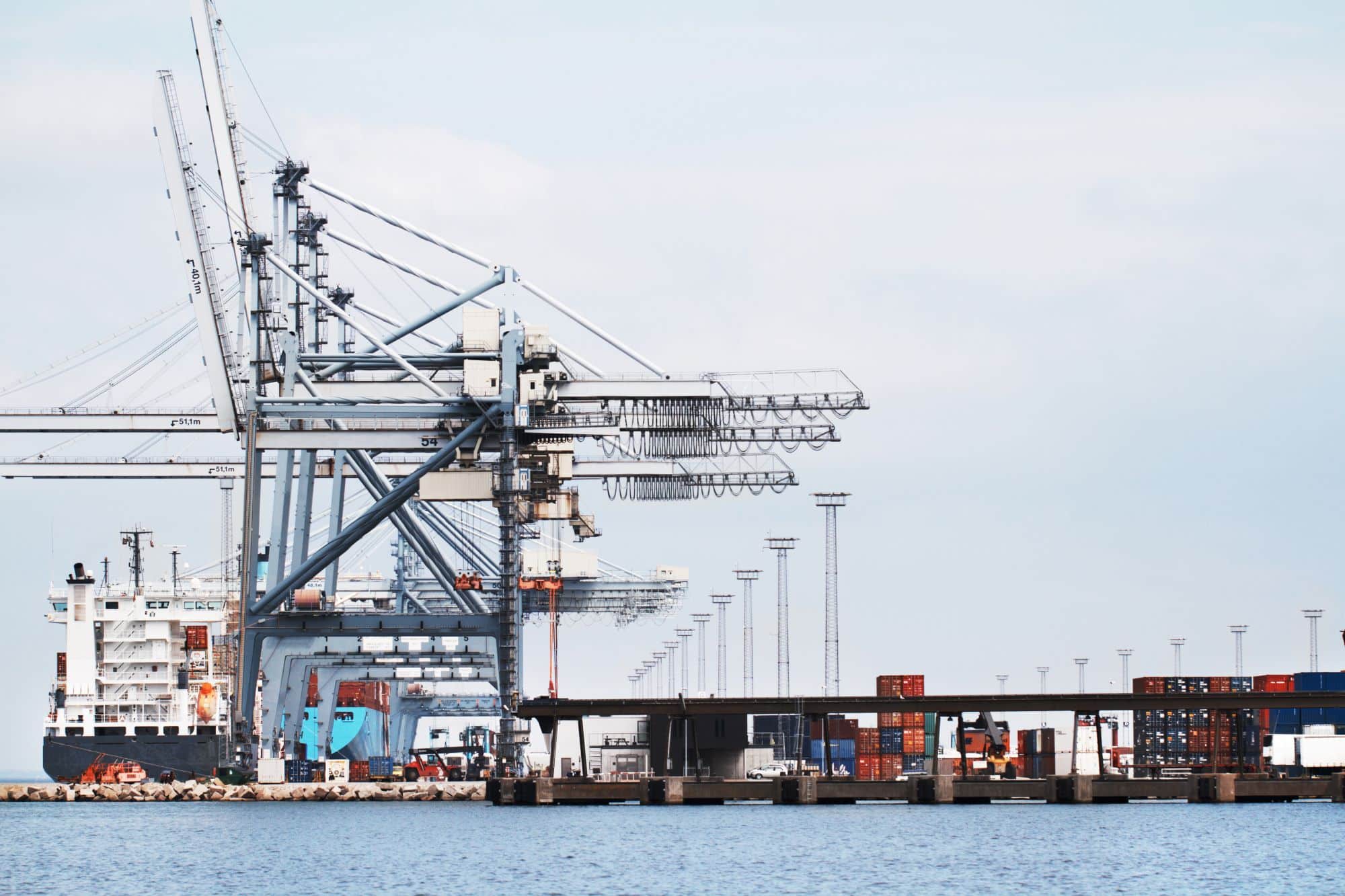 Gantry cranes loading a container ship at a harbor