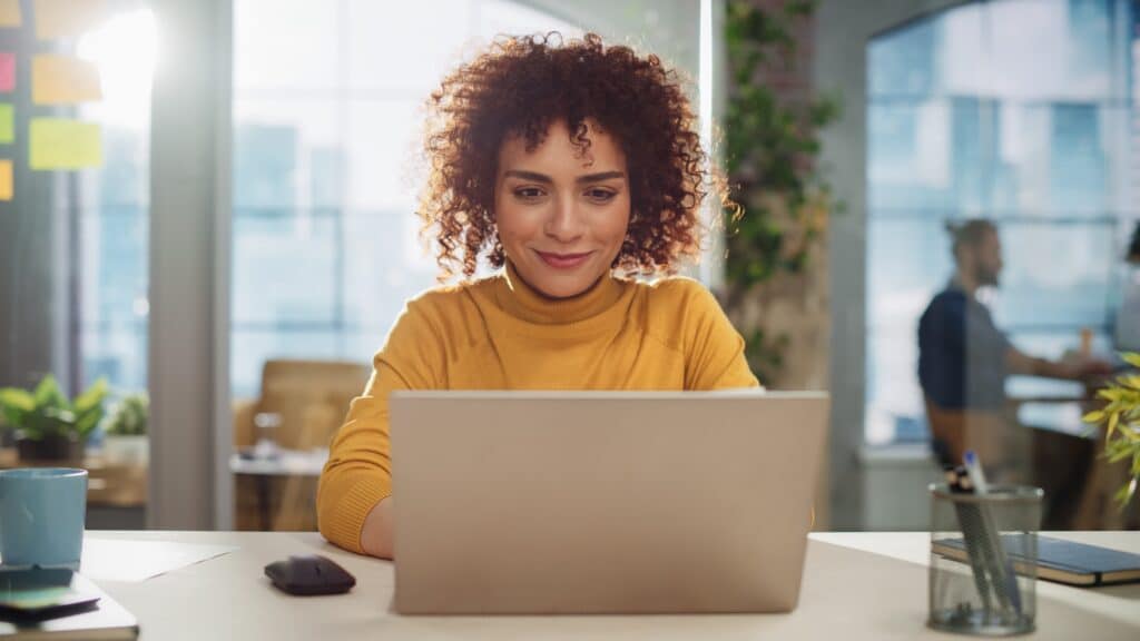 Woman working on laptop at desk