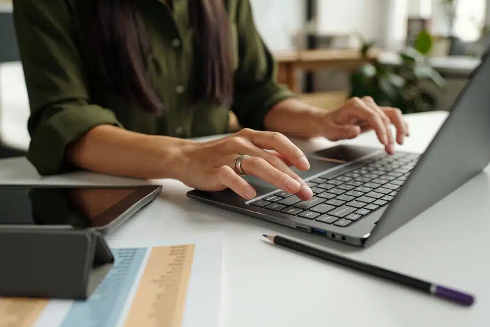 female hands typing on laptop tradacoms edi portal