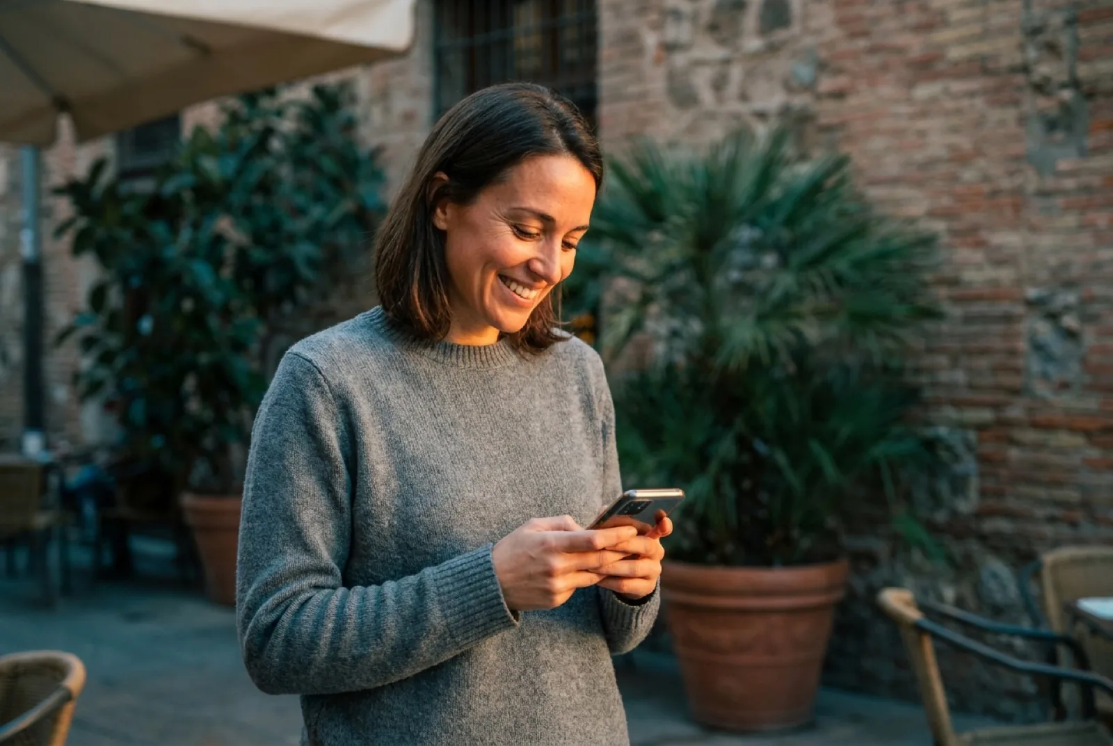 Smiling woman holding a phone