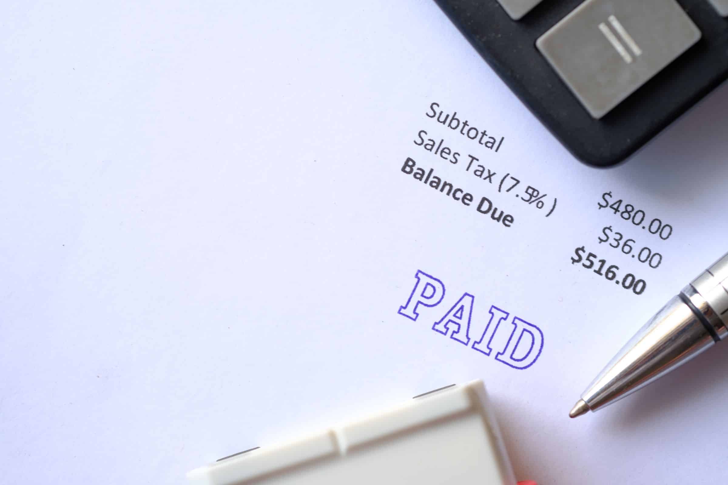 Paid invoice with a rubber stamp on paper