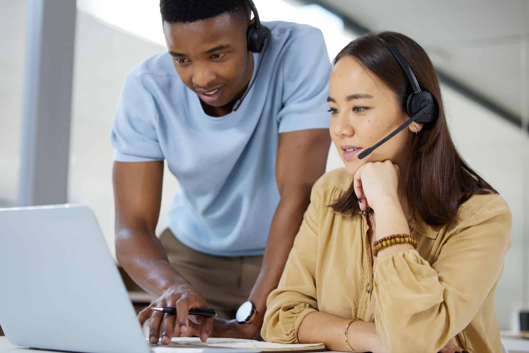 Two businesspeople working together on a laptop