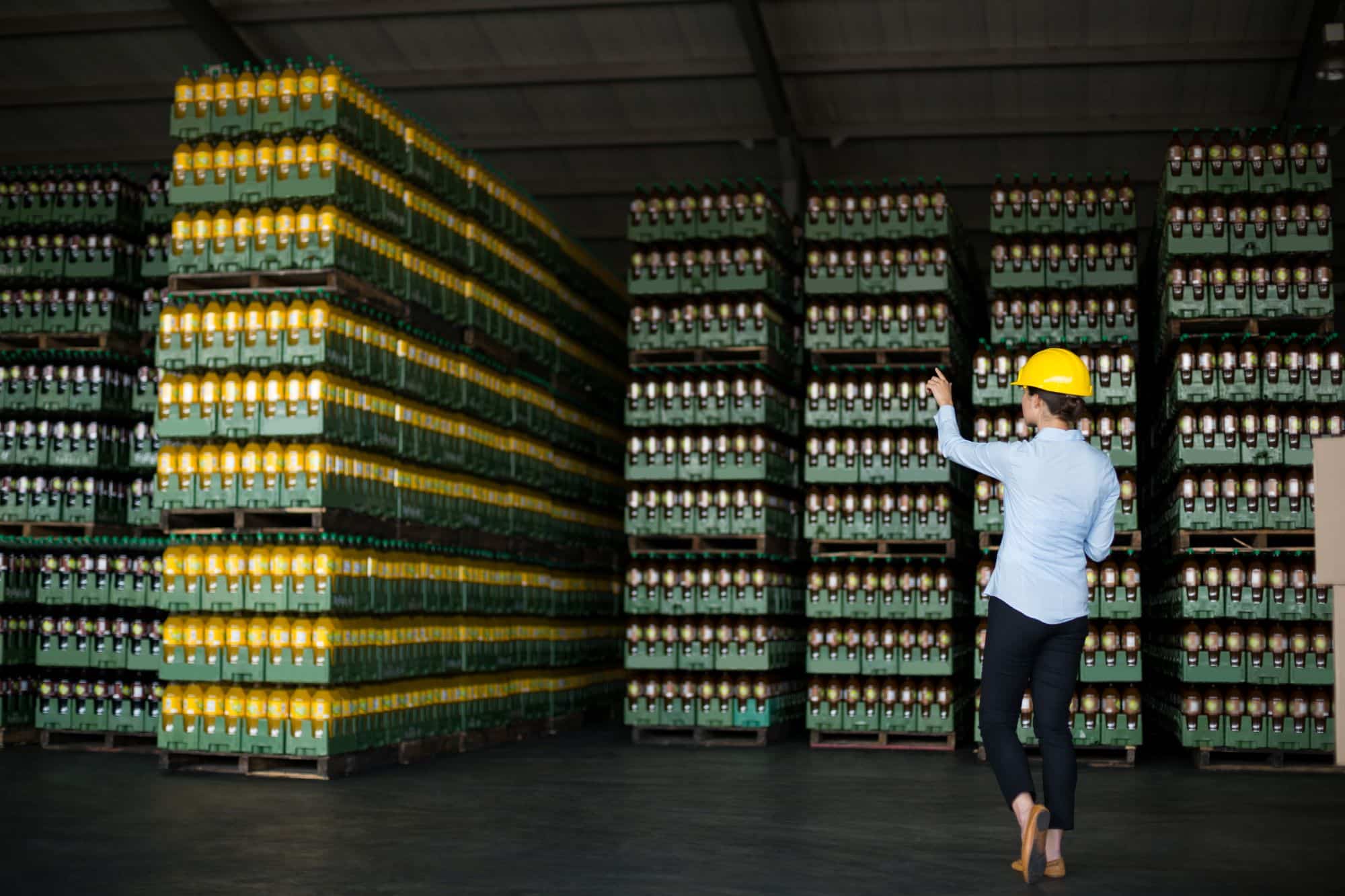 Female factory worker directing where products should be stored in factory