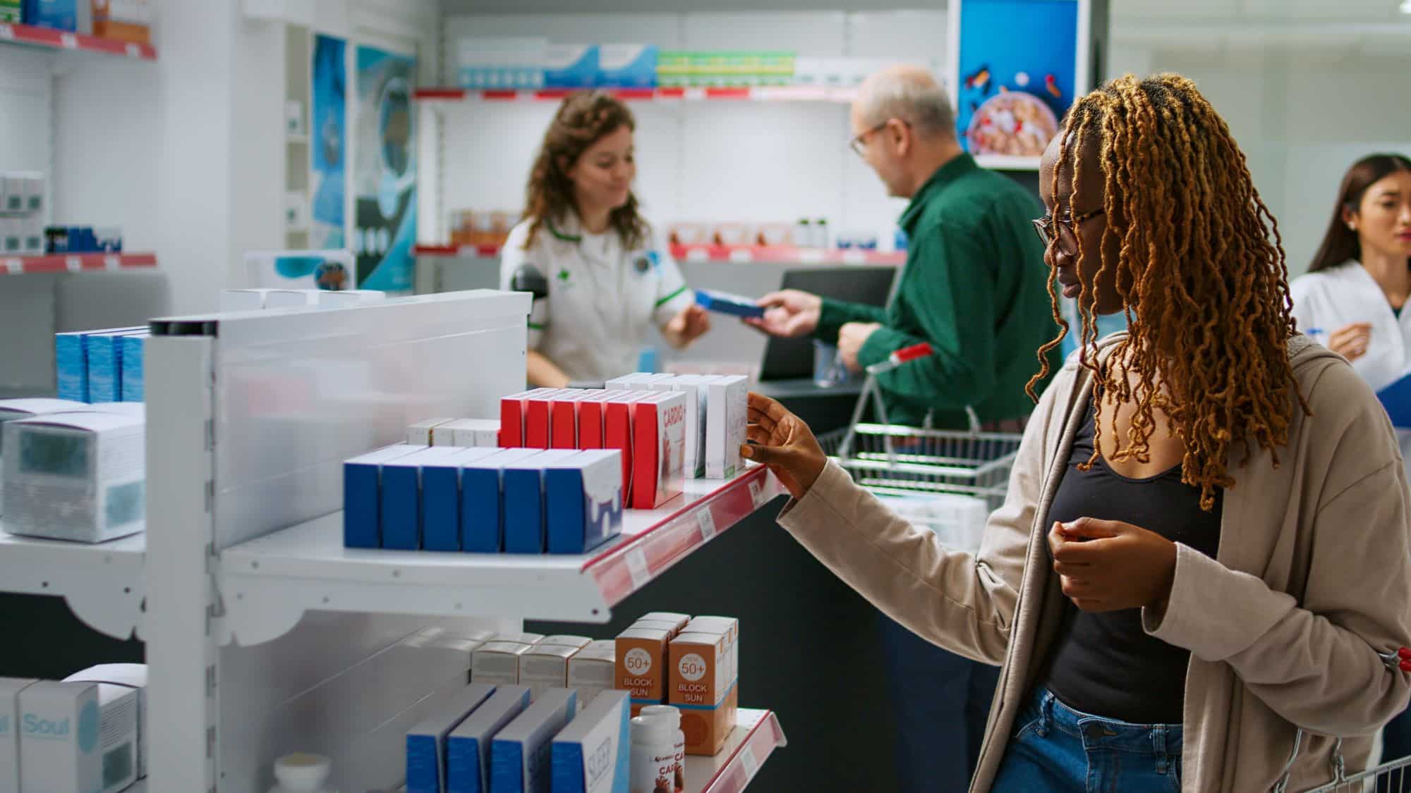 Young adult looking at boxes of medicaments