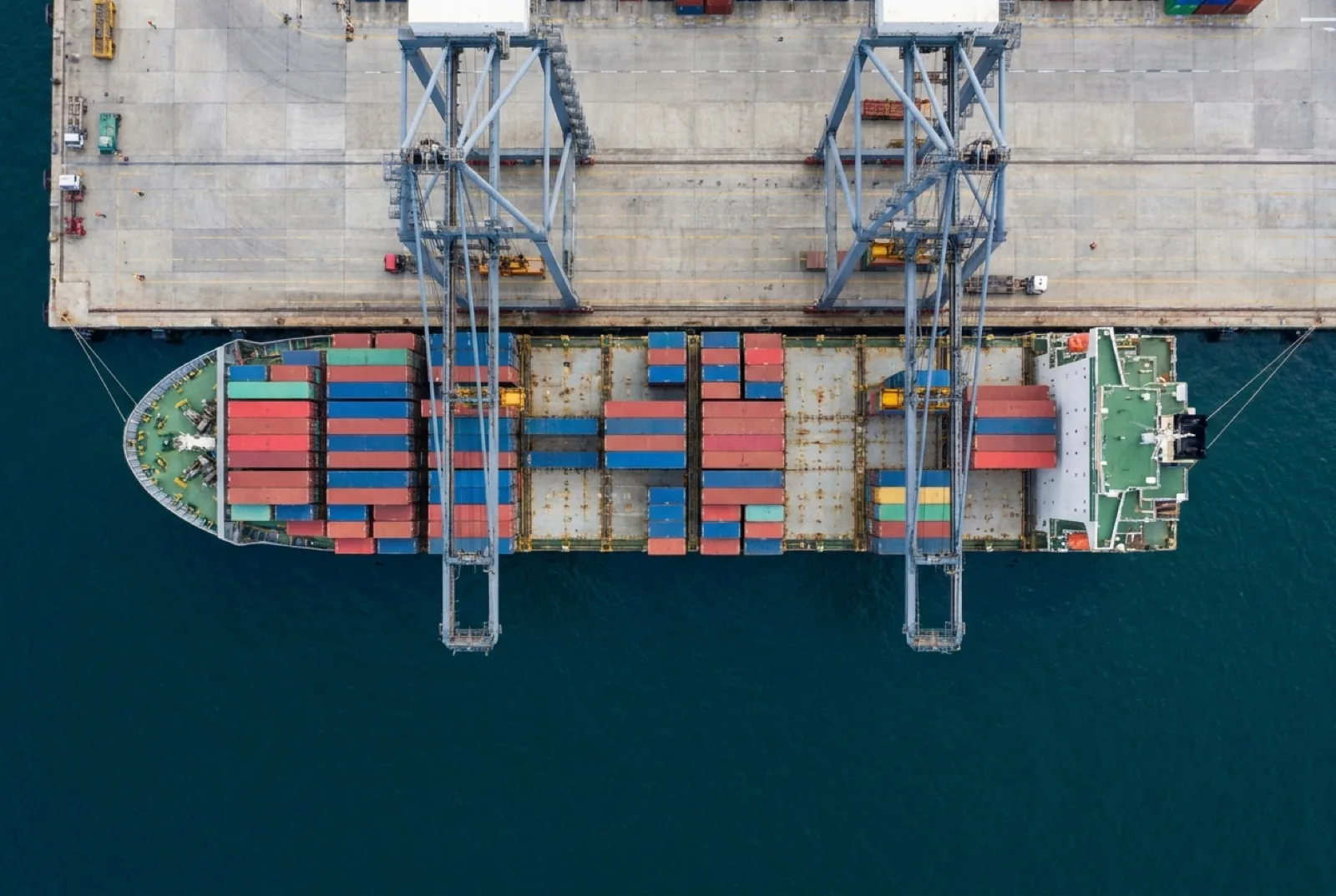 Aerial view of a cargo ship being loaded at port