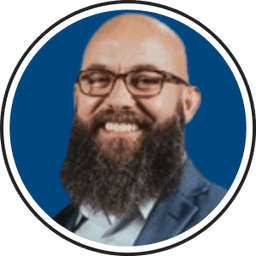 Professional headshot of Chad, bald man with beard and glasses smiling
