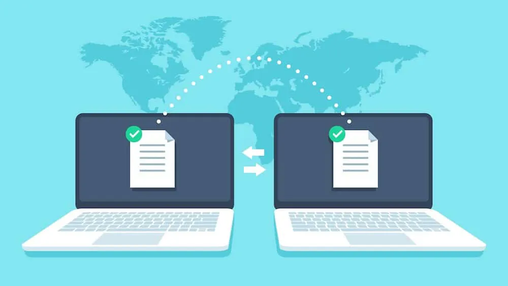 Two laptops exchanging documents globally via EDI VAN network connection
