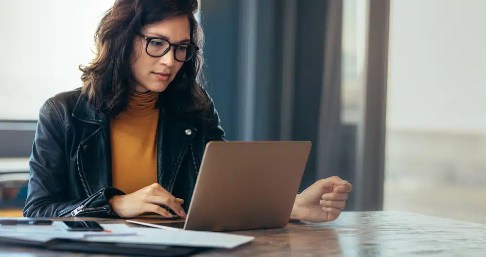 businesswoman learning about ANSI X12 on her laptop