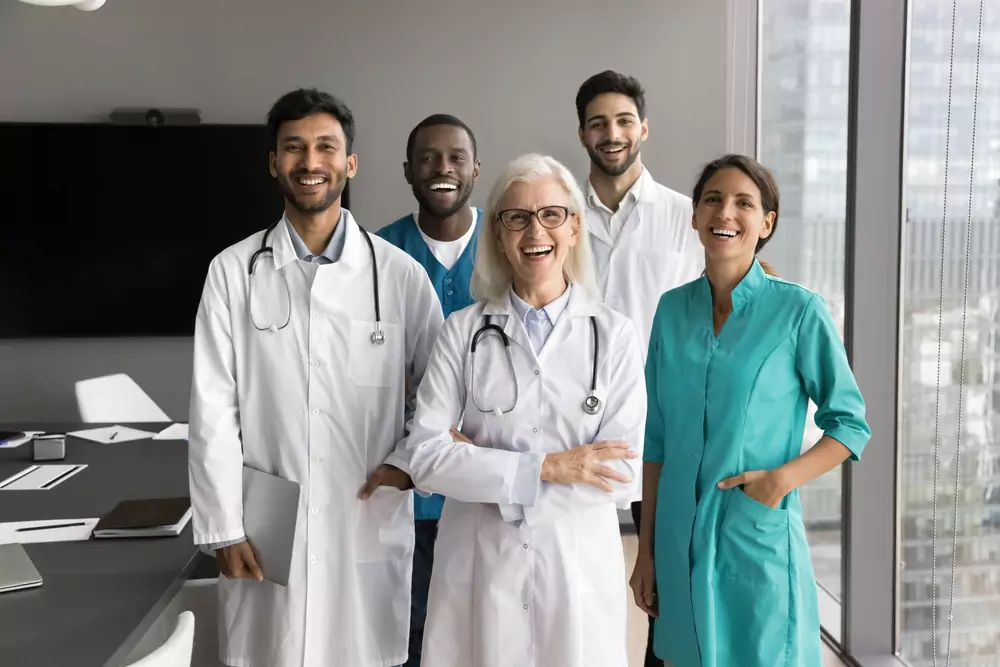 Doctors and nurses standing in a group and smiling