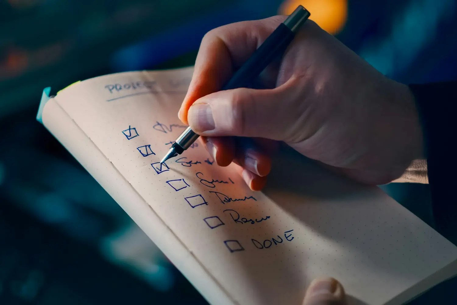 Hand ticking off items on a printed checklist