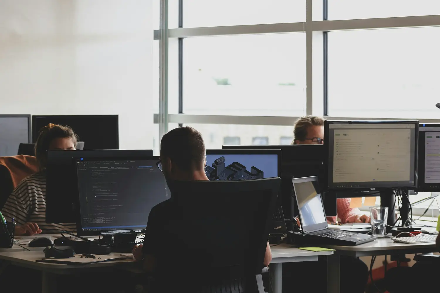Operations team working at computer monitors