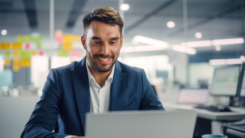 a man in suit looking at his computer