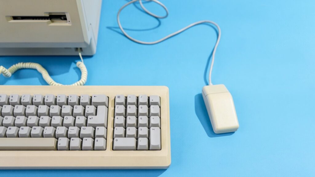 an old computer, mouse and keyboard with a floppy disk slot