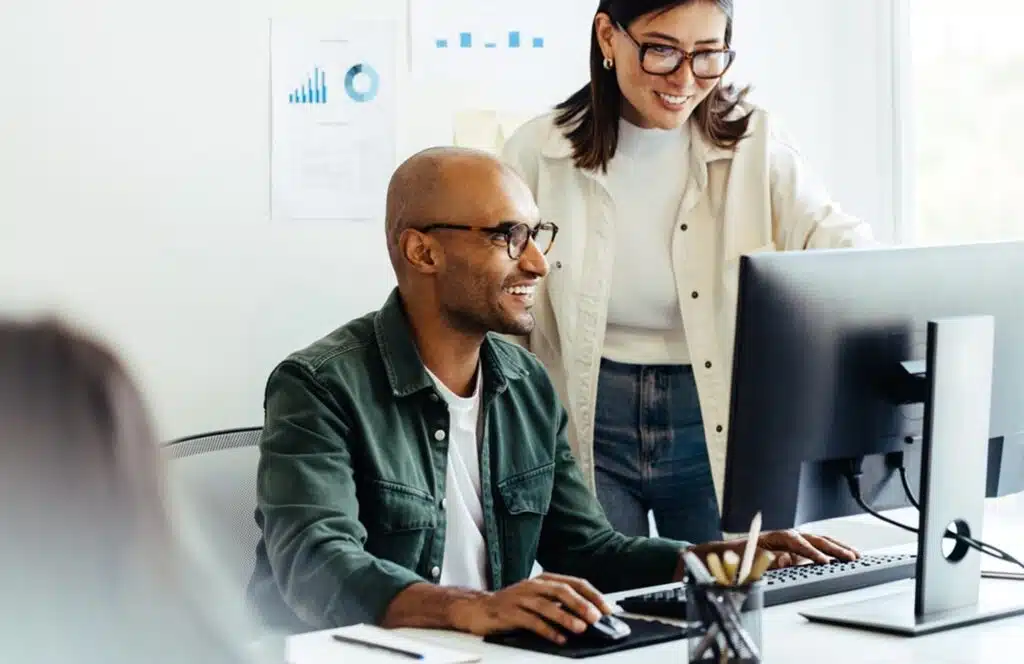 man and woman looking at a computer screen