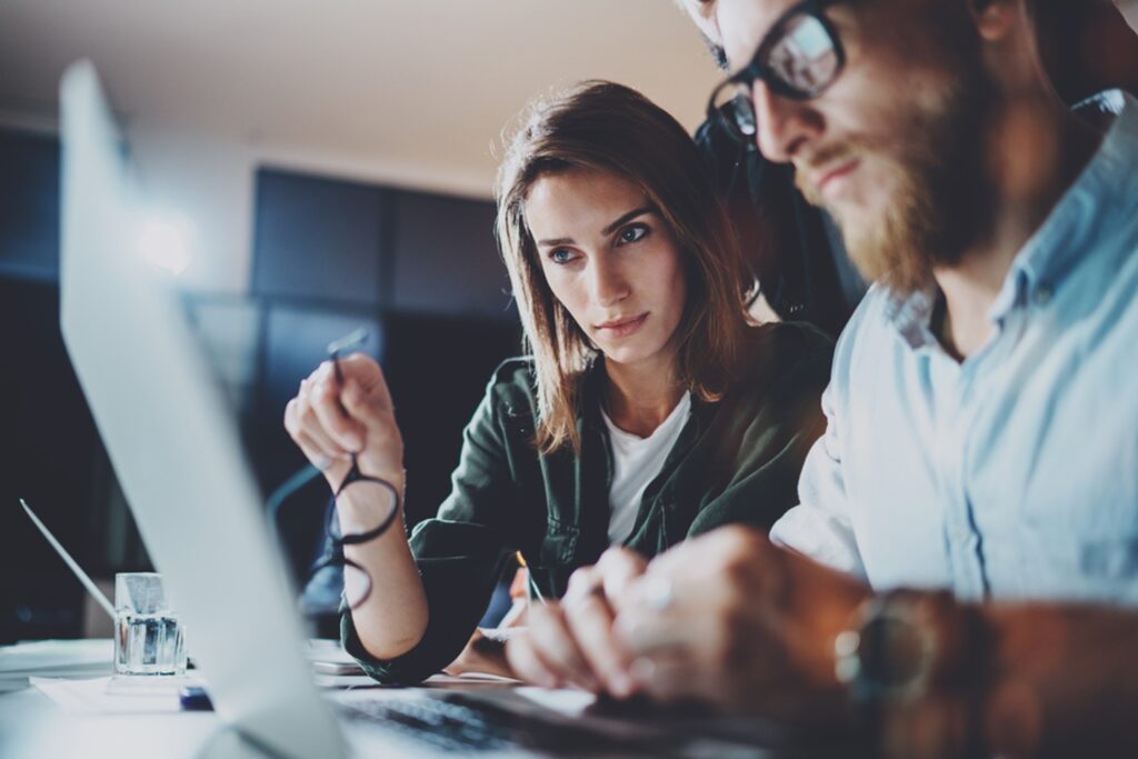 man and women looking at a laptop screen