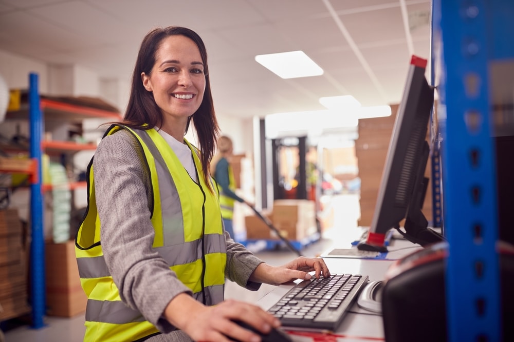 woman at a computer in a warehouse