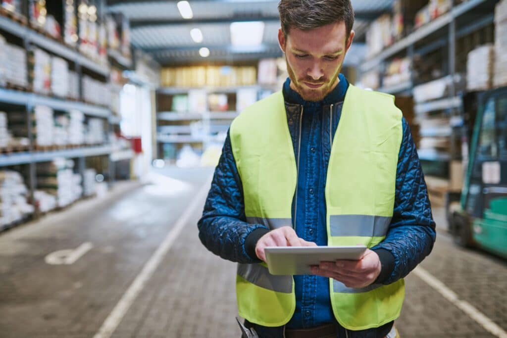 warehouse worker looking at a tablet