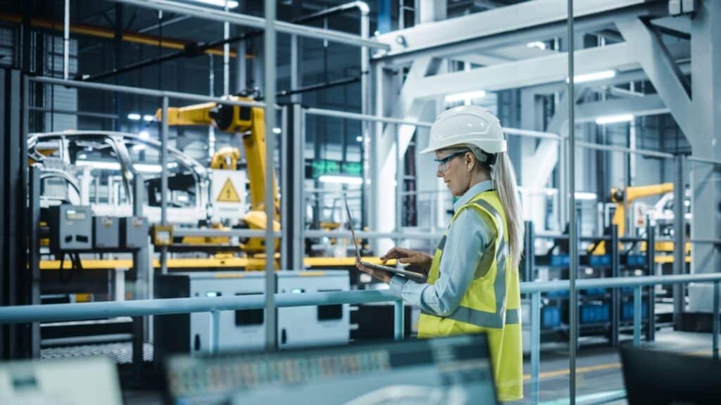 woman on a computer at a automotive manufacturing facility