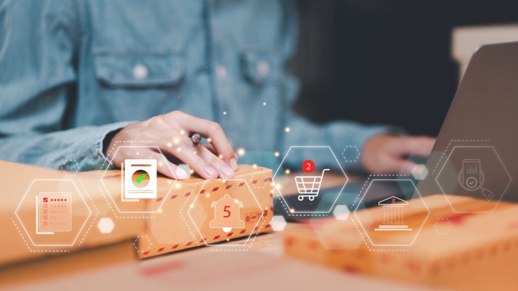 women on computer checking stock of an item with overlay of icons for ecommerce, dollar sign, and a chart