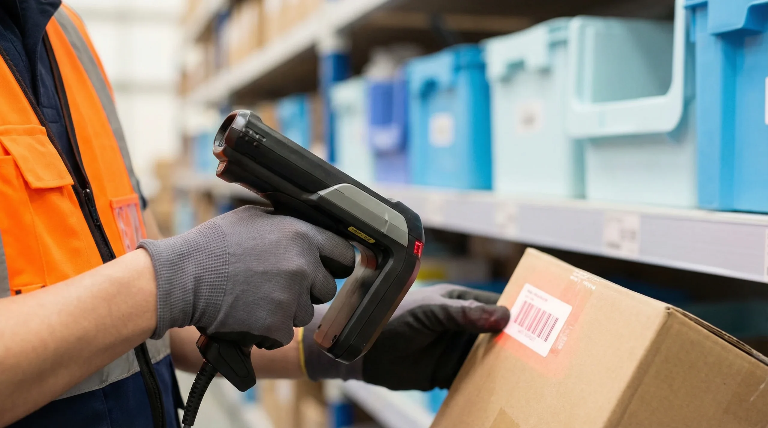Warehouse worker scanning barcode on package